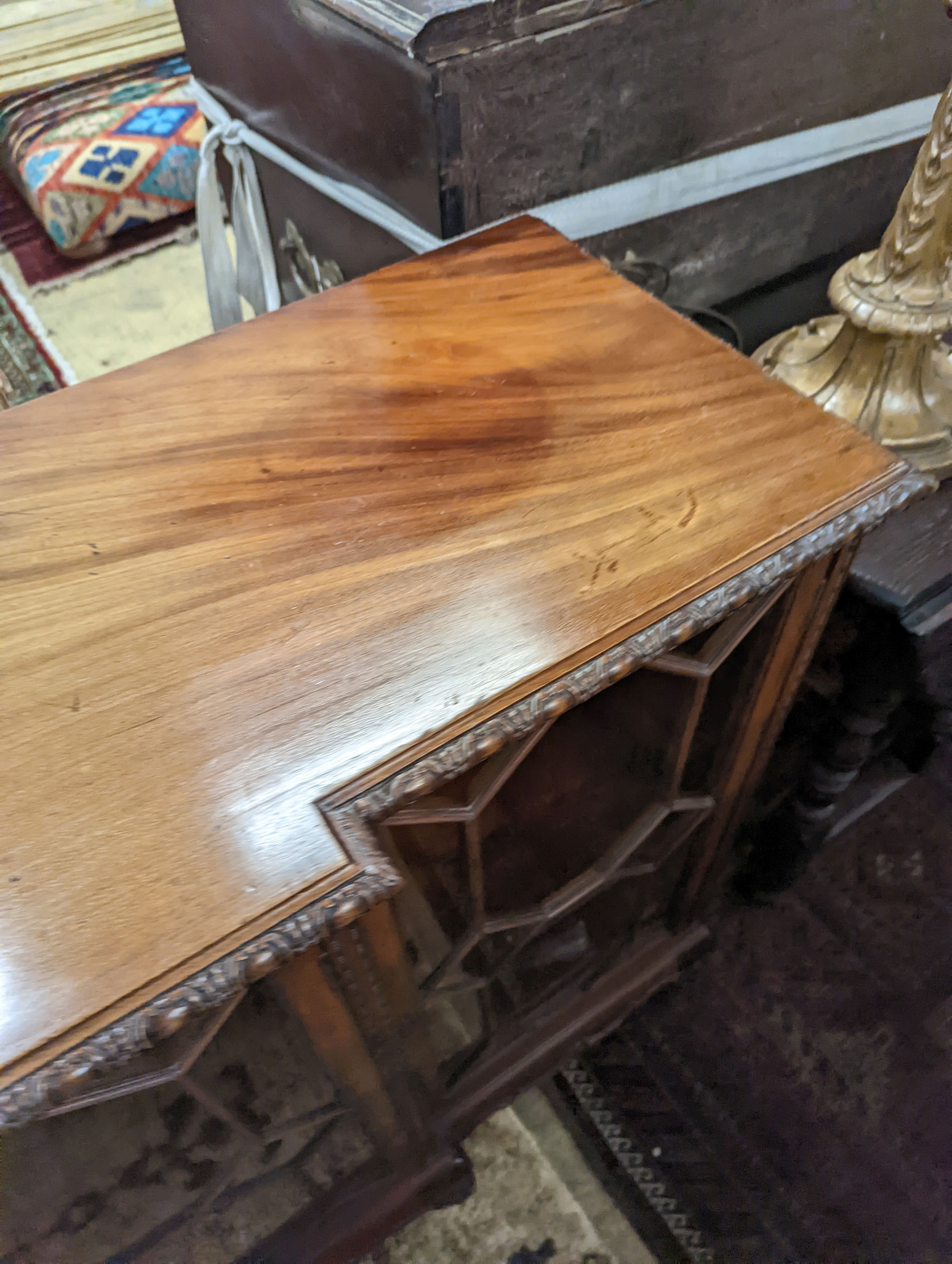 A 1920's Chippendale revival glazed mahogany break front dwarf cabinet, width 160cm, depth 43m, height 88cm